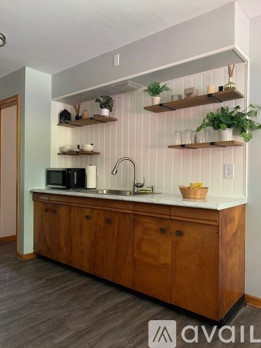 A kitchen with wooden cabinets and a white countertop.