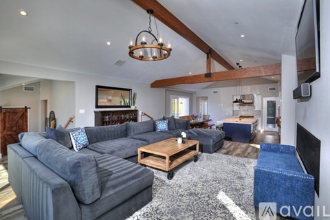 A living room with a grey couch and a wooden coffee table.