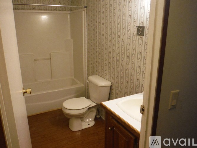 A bathroom with a toilet, sink, and bathtub.