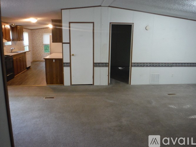 A room with a door and a wall with a black door.