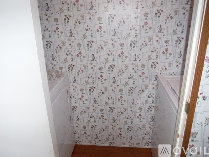 A wallpaper with a floral pattern covers the wall.