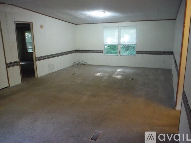 A room with a concrete floor and a window.