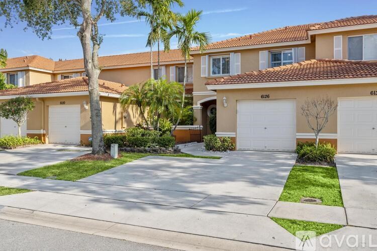 A row of houses with garages and driveways.
