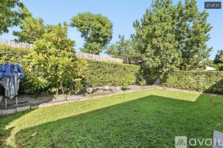 A backyard with a lawn and trees.