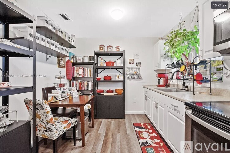 A kitchen with a table and chairs in the middle of the room.