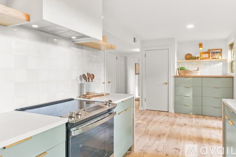A kitchen with a stove top oven and a counter top.