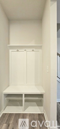 A room with a carpeted floor and a white wall.