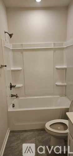 A bathroom with a toilet and a bathtub.