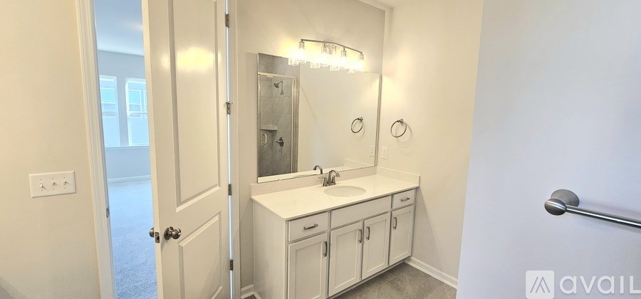A bathroom with a sink, mirror, and cabinets.