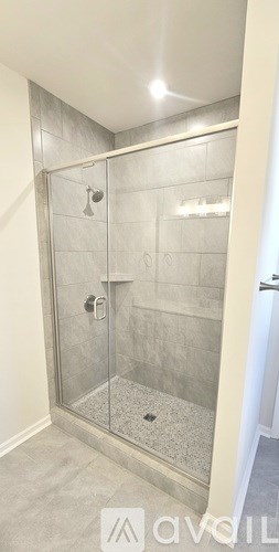 A modern bathroom with a walk-in shower.