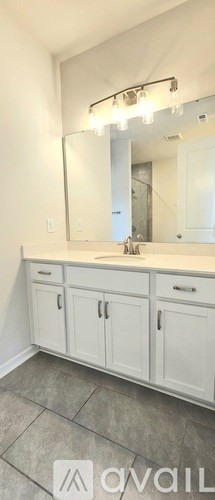 A bathroom with a vanity and a mirror.