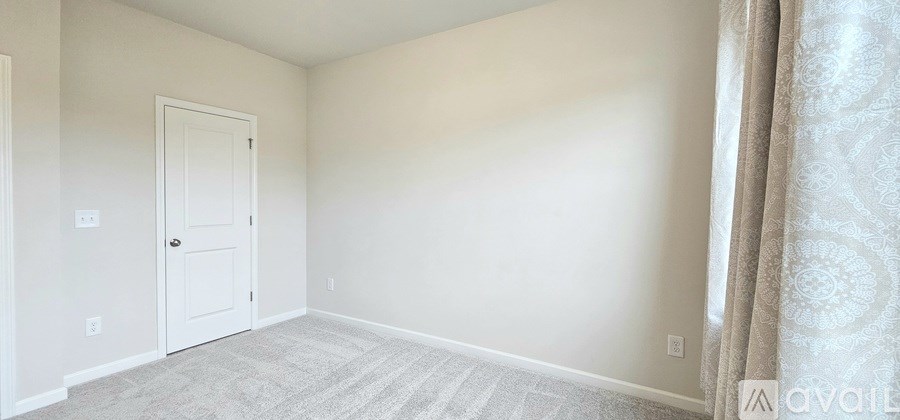 A room with a door and a carpet on the floor.