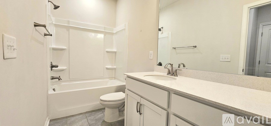 A bathroom with a toilet, sink, and bathtub.