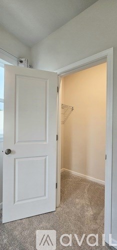 A white door is open to a hallway.