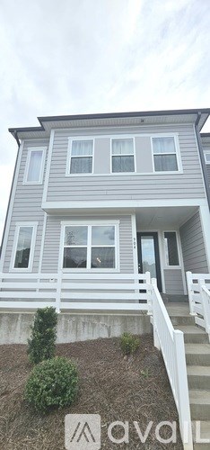 A hallway with a wooden floor and a chandelier.