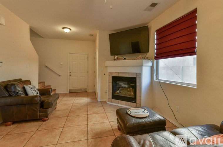 A bedroom with a bed, a ceiling fan, and a window with blinds.