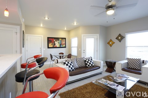 A living room with a checkered couch and a coffee table.