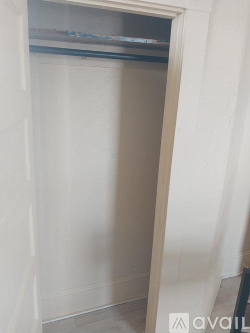 A white closet with a shelf above the door.