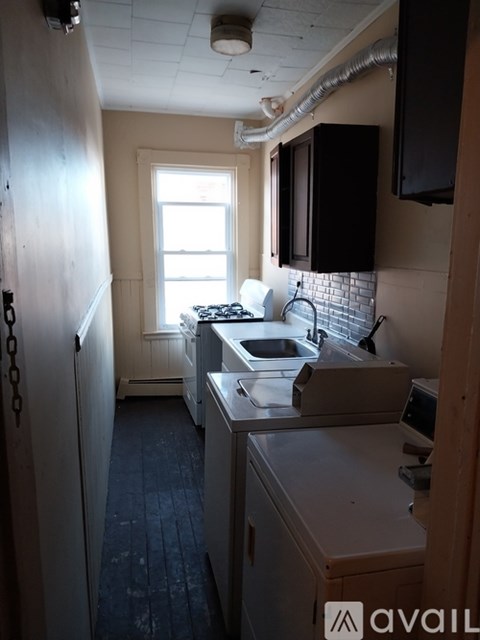 A kitchen with a sink and a window.