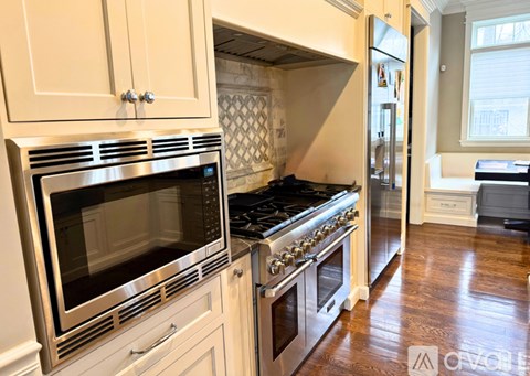 A kitchen with a stove top oven and microwave.