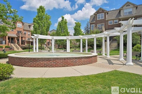 A white pergola is over a hot tub in a grassy area.