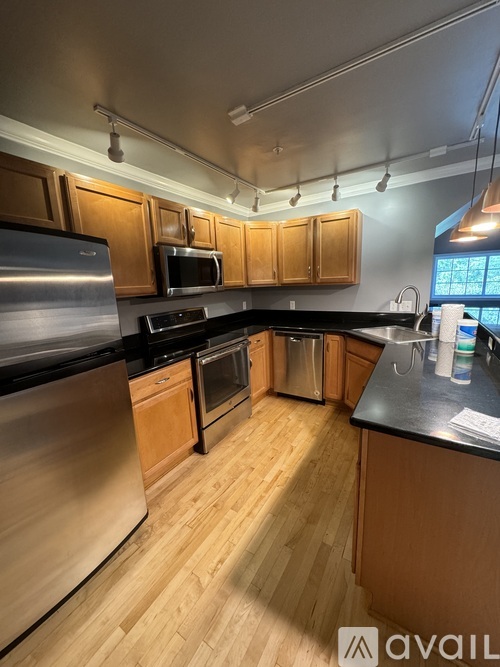 A kitchen with wooden cabinets and stainless steel appliances.
