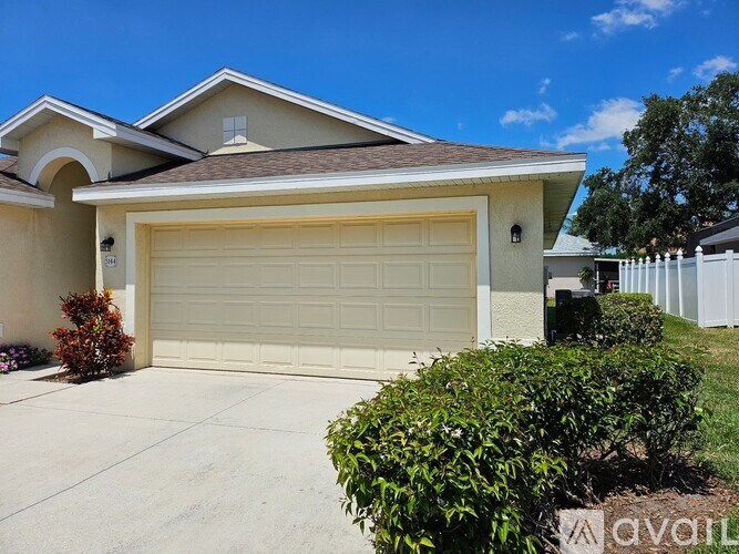 A house with a large garage door and a driveway.