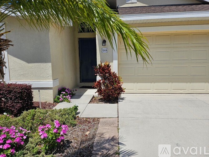 A house with a garage door and a sign that says "Shore".