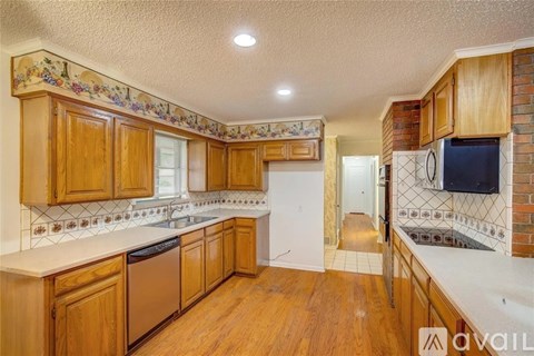 A kitchen with wooden cabinets and a white countertop.