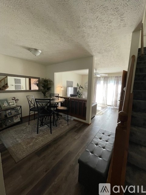 A living room with a dining table and chairs.
