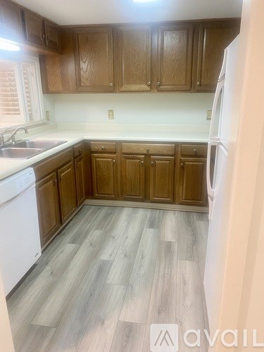 A kitchen with wooden cabinets and a white refrigerator.