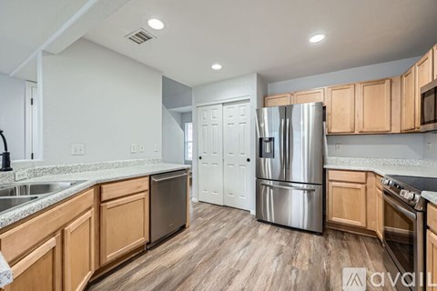 A kitchen with wooden cabinets and a white fridge.