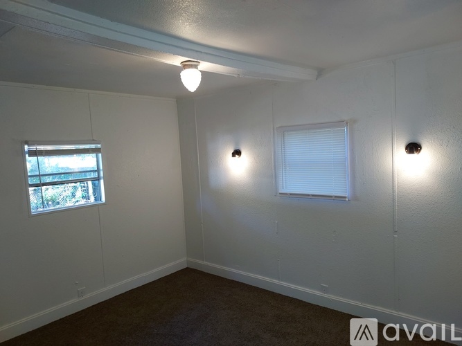 A room with a window and two wall lights.