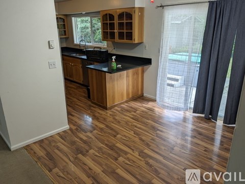 A kitchen with wooden floors and cabinets is available for rent.