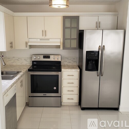 A kitchen with a stainless steel refrigerator and oven.