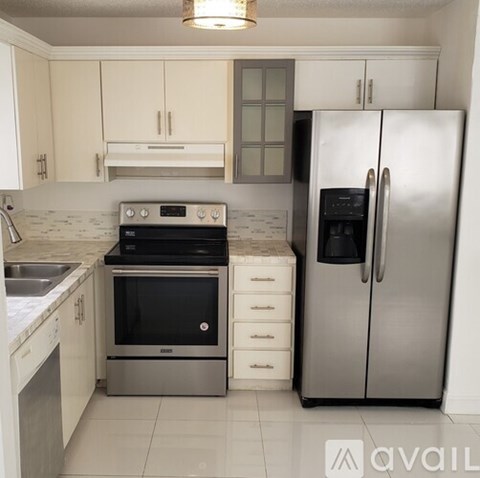 A kitchen with a stainless steel refrigerator and oven.