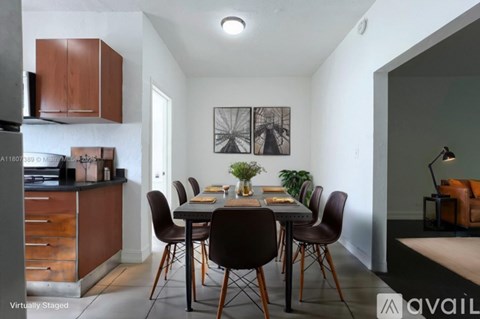 A modern dining room with a table set for four.