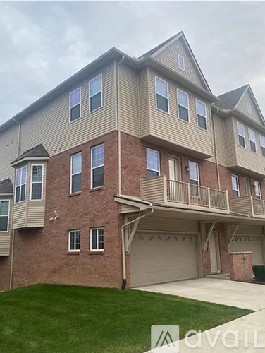 A two-story residential building with a garage on the lower level.