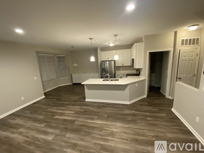 A spacious kitchen with a bar area and a dining table.