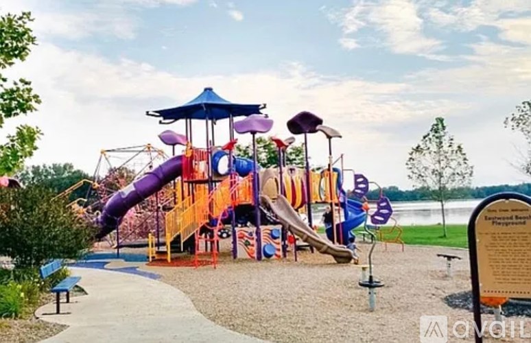 A playground with a purple slide and a yellow and orange structure.