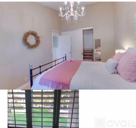 A bedroom with a large bed, a dresser, and a painting on the wall.