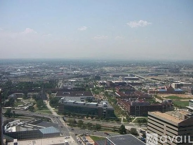 A cityscape with buildings and roads under a clear sky.
