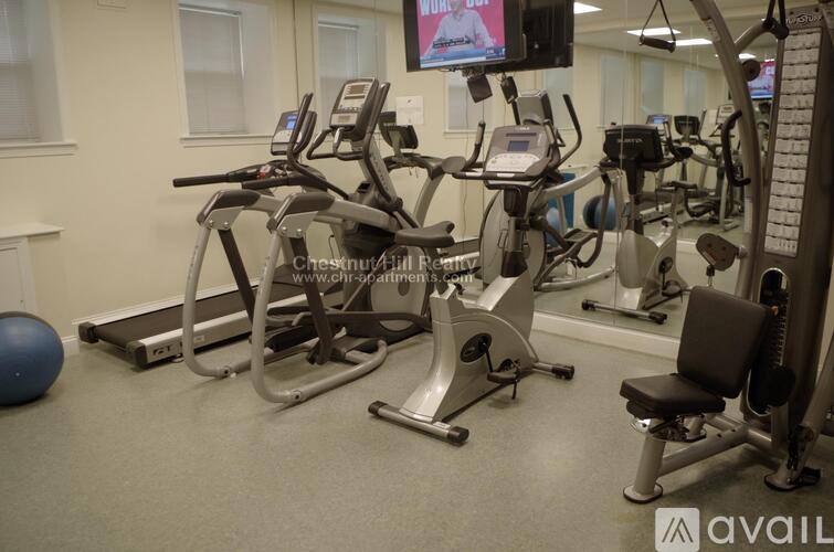 A gym with treadmills, exercise bikes, and other equipment.