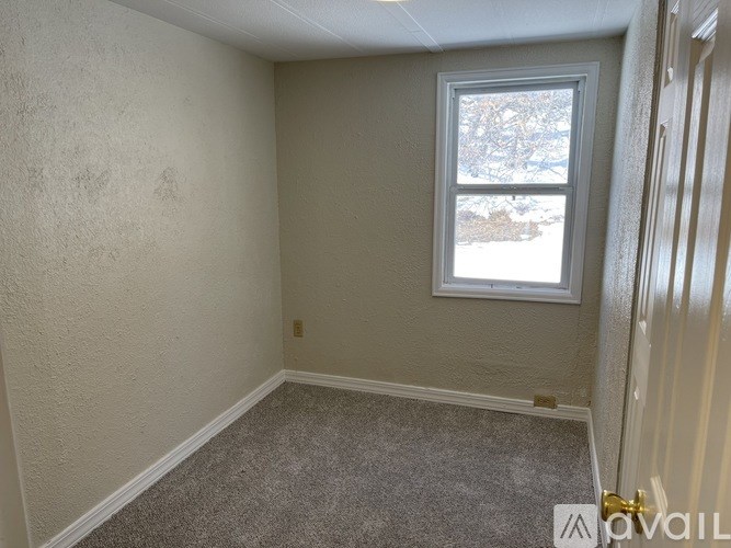 A room with a window and a door.