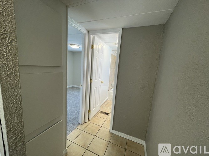 A hallway with a door at the end.