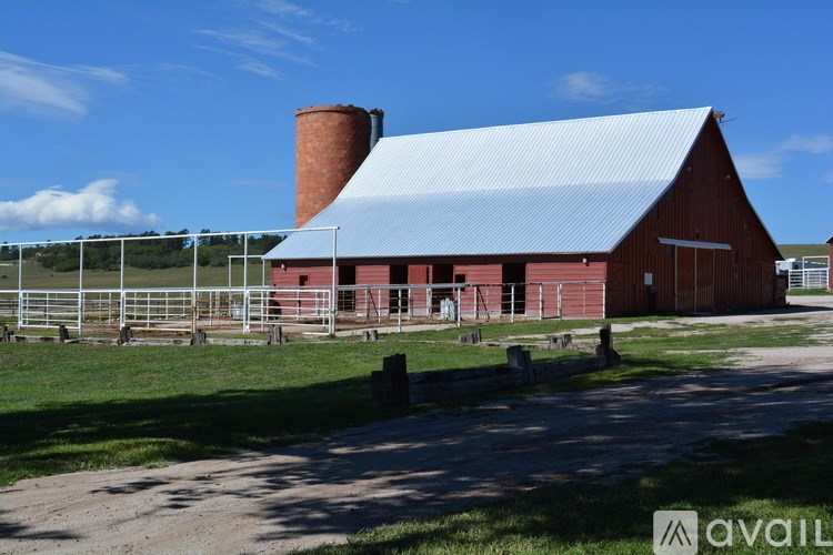A red barn with a blue roof and a chimney.