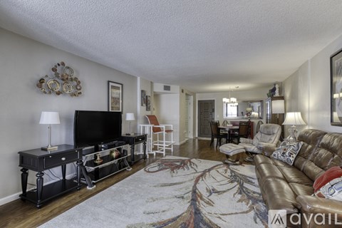 A living room with a brown couch and a television.