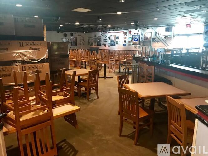 A restaurant with wooden chairs and tables is shown.