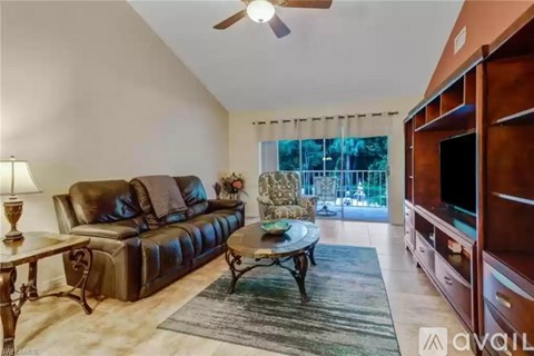 A living room with a brown leather couch and a wooden coffee table.
