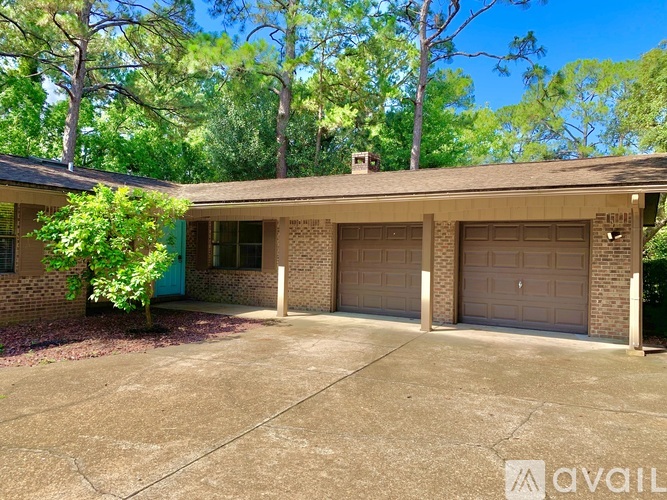 A house with a blue door and two garage doors.